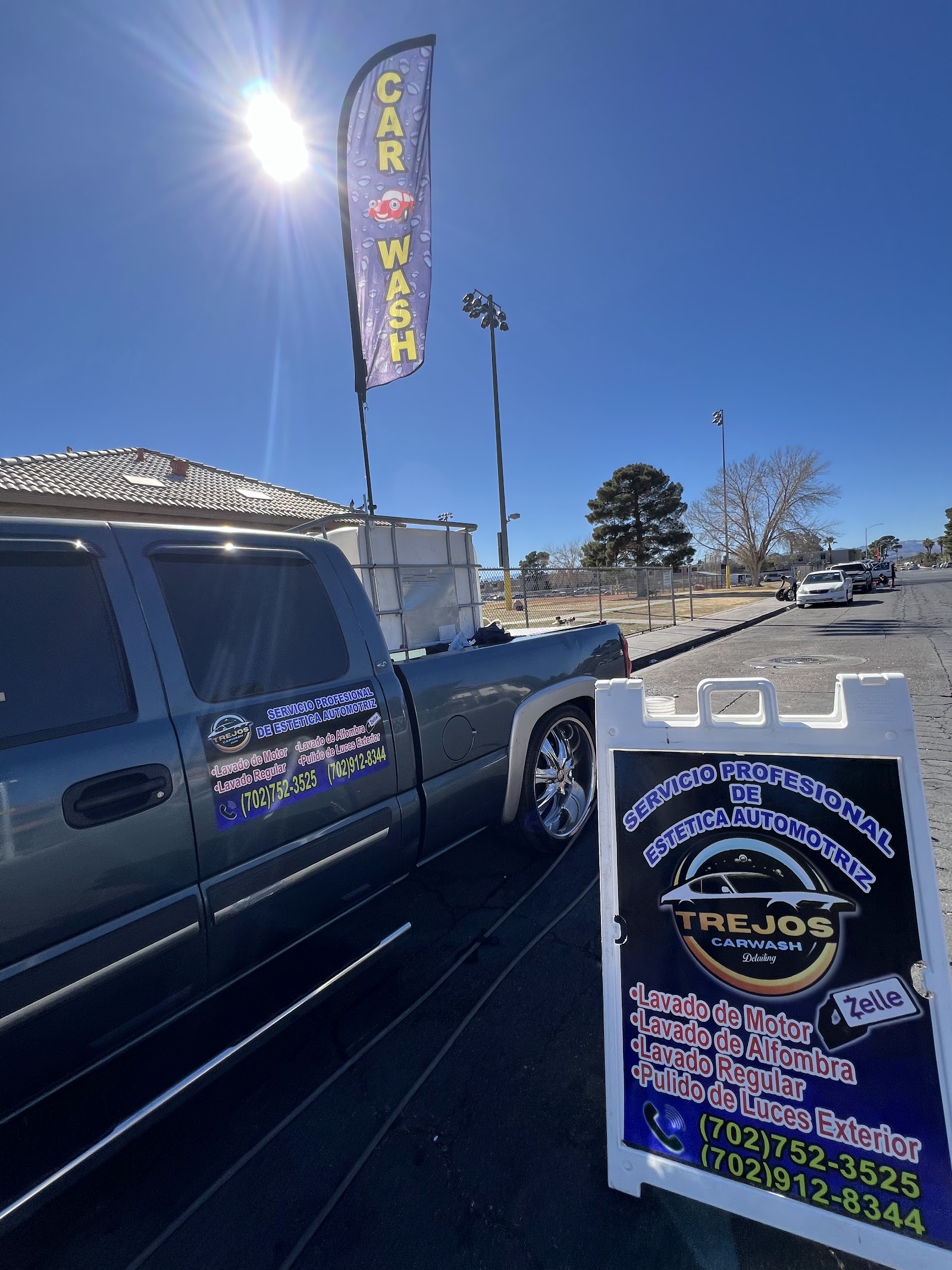 Detailed pickup truck with Trejos Carwash branding and a sandwich-board sign
