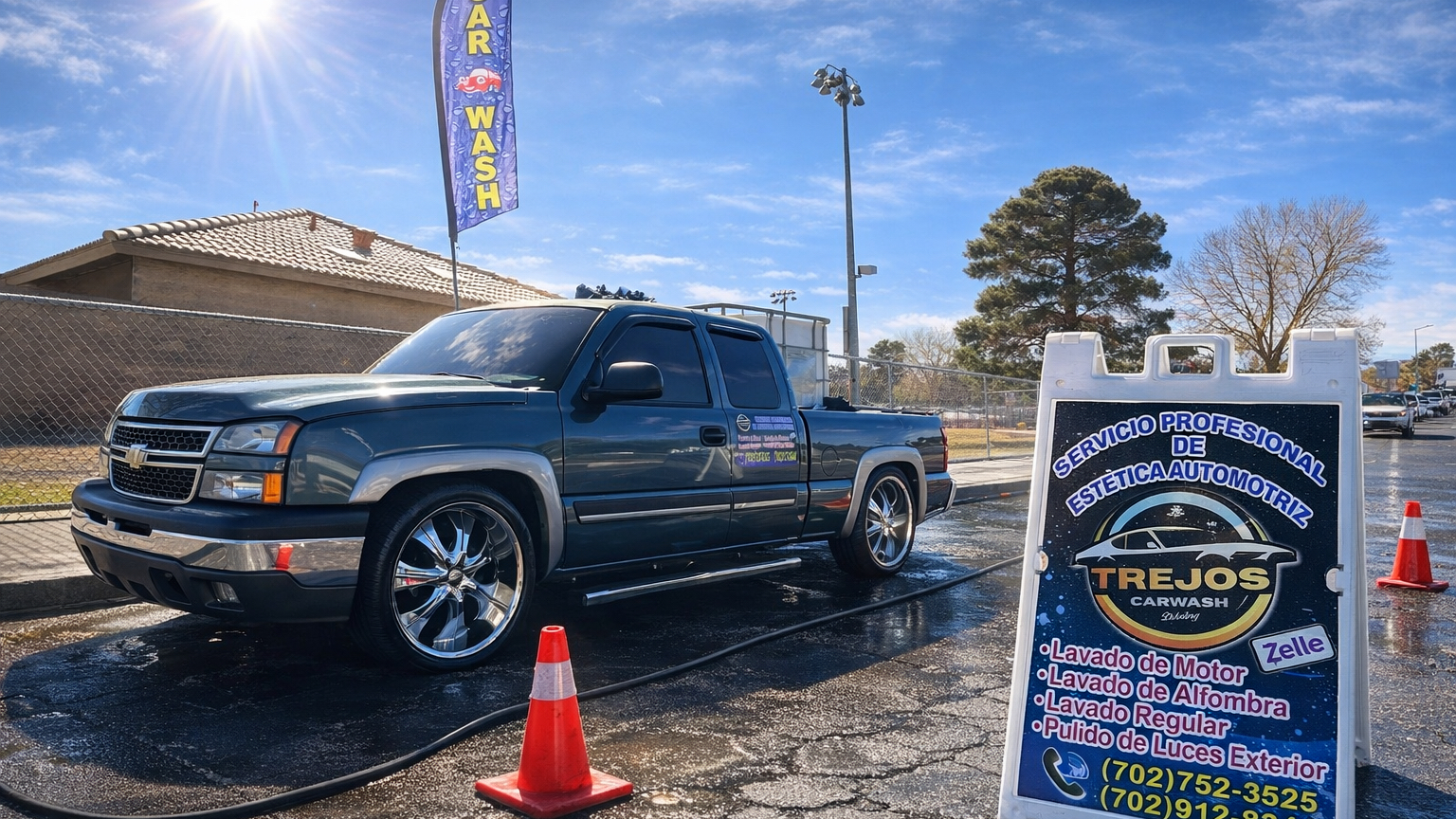 Clean, detailed Chevrolet Silverado on chrome rims beside the Trejos Carwash sign and a car wash flag